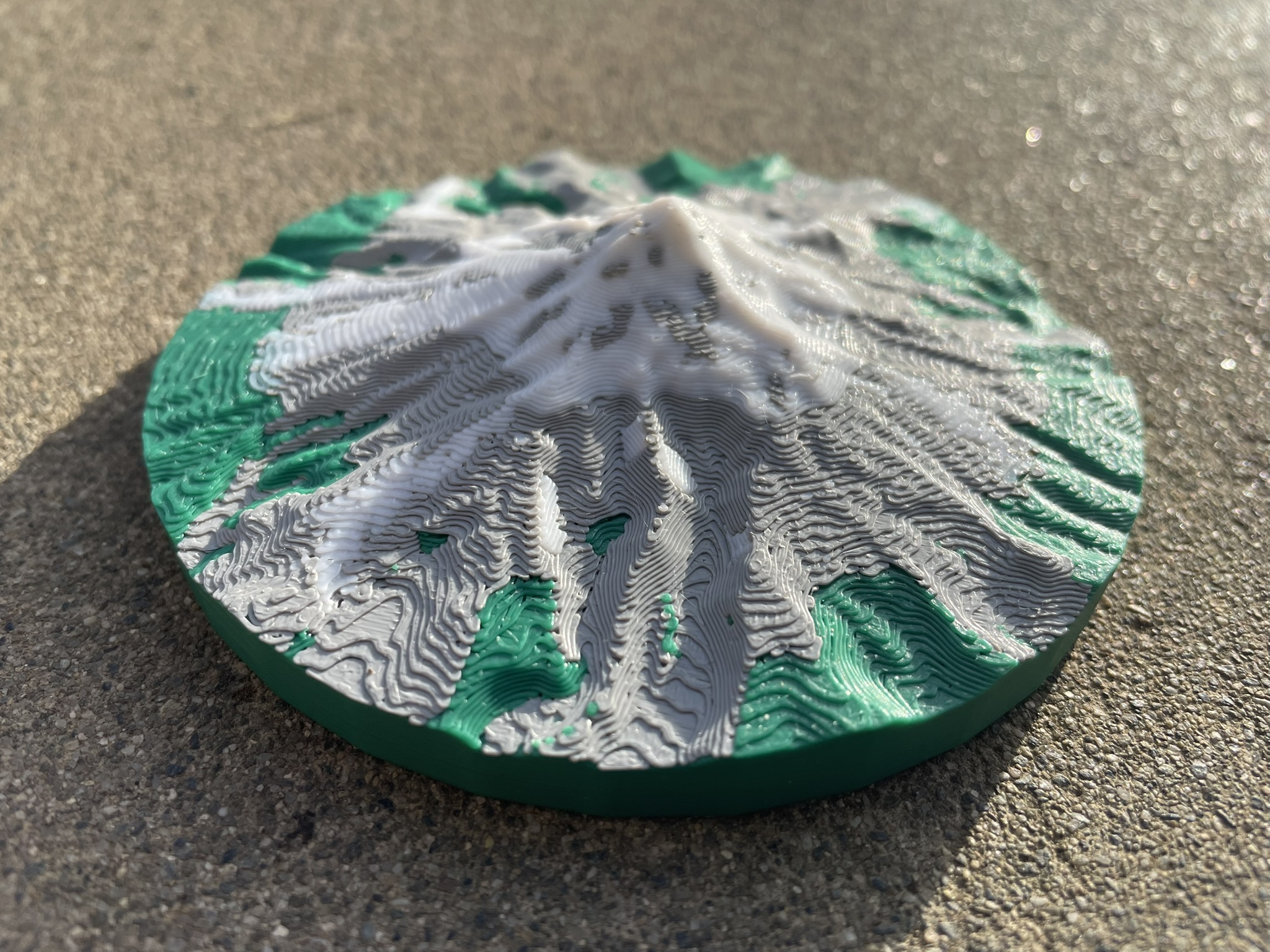 A 3D printed model of Mount Hood on a circular base